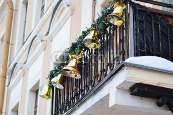 greenery garlands with large bells look very festive and bold and will instantly give a holiday feel to the space