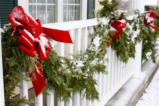 simple evergreen garlands with red bows are traditional decorations for winter and holidays, and they are easy to attach