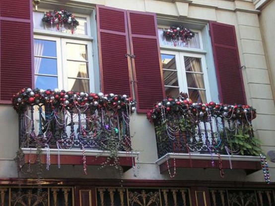 mini balconies decorated with lots of Christmas ornaments, bead garlands, lush foliage and blooms for a strong holiday feel,