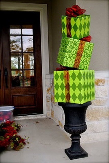 a vintage urn with bold green and red bow gift boxes, which is a lovely and bright decoration for Christmas and is easy to make