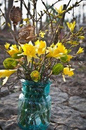 a blue jar with daffodils and dried branches is a pretty spring decoration for spring, it’s easy to compose