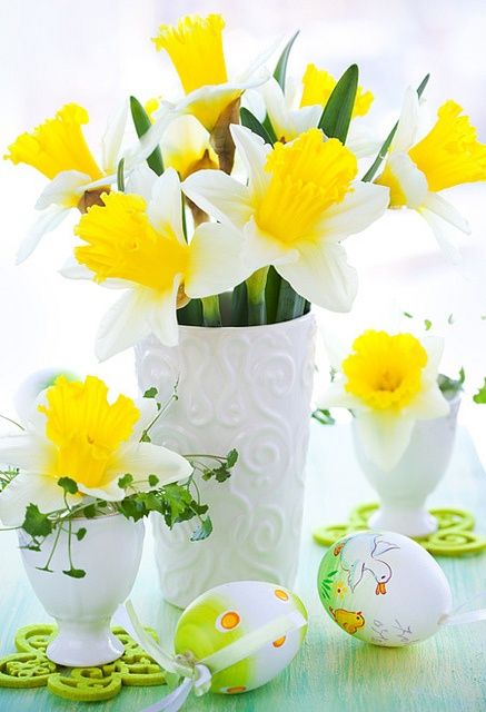 a classic white vase and a couple of egg stands with daffodils and greenery will make up a cool spring centerpiece