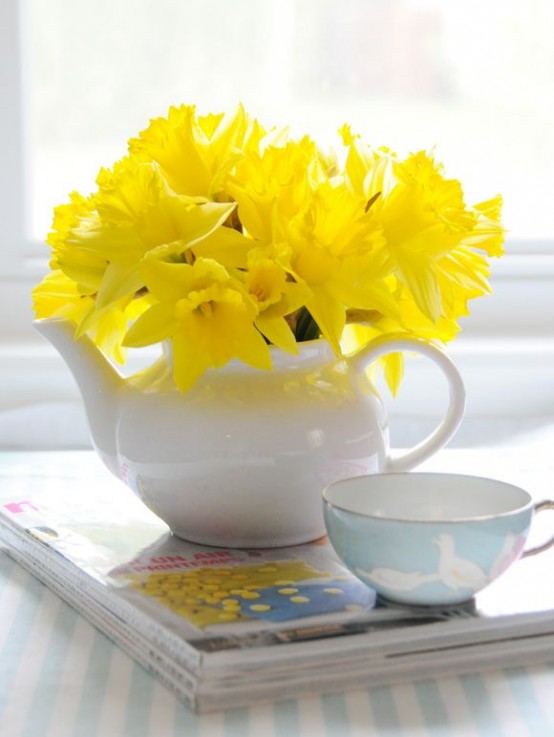 a white teapot with daffodils is a pretty and cool spring decoration you can make anytime