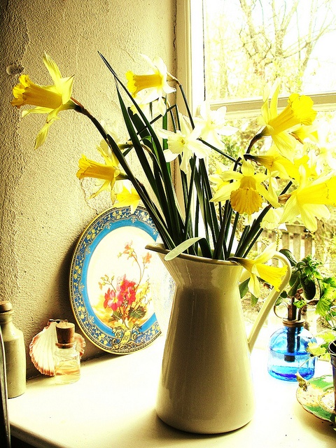 a jug with daffodils is a pretty and cool idea for a rustic or farmhouse space, to feel the spring