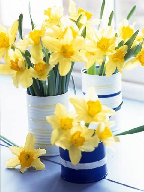 striped tin cans with daffodils are amazing for bright and fun spring decor and can be used in any room