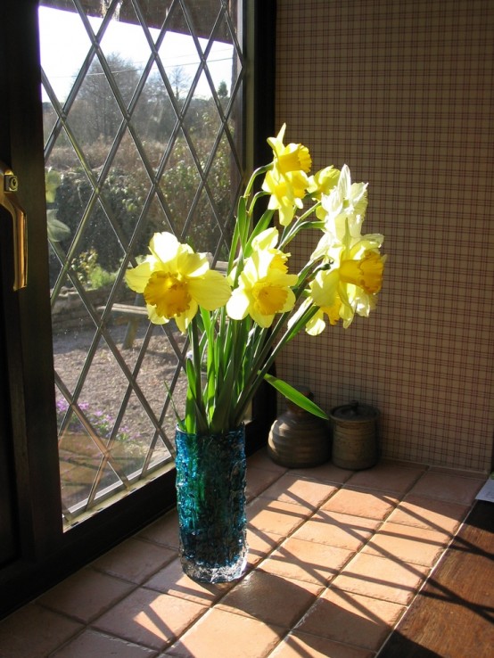 a blue vase with daffodils is a bold and cool spring decoration for any space, enjoy fresh blooms and colors