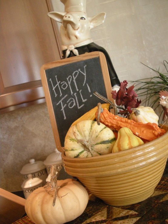 a porcelain bowl with faux gourds, pumpkins, leaves is a cool idea to add a fall feel to the space