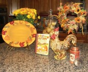 a bright fall flower arrangement and a wreath of fall blooms and leaves for traditional fall kitchen decor