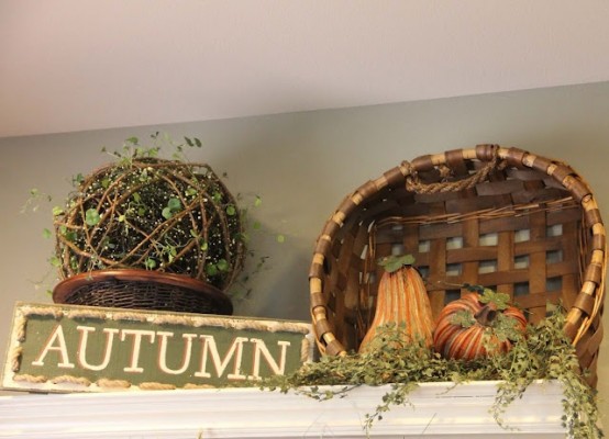 a vine ball with greenery, a basket with faux gourds and faux greenery plus a simple sign for a fall kitchen