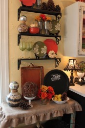 oversized pinecones, fall-colored and painted plates, bright blooms and citrus for fall kitchen decor