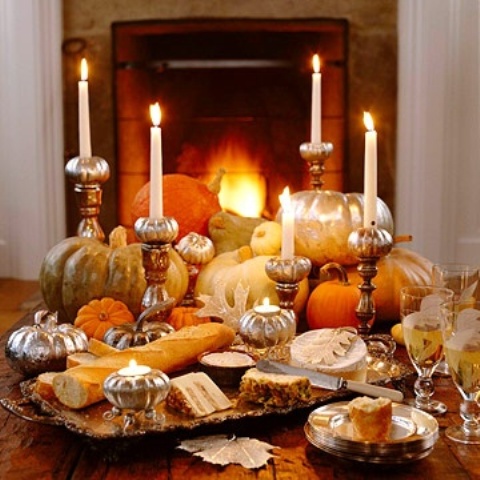 cool fall party decor realized with faux pumpkins in various colors and metallics plus candles in refined tall and pumpkin candleholders