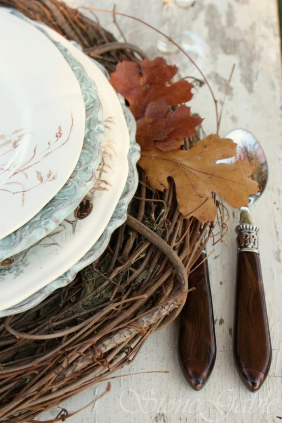 style place settings with woven placemats, printed plates and natural fall leaves