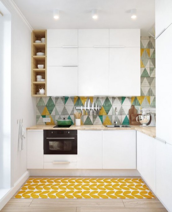 a modern white kitchen with bright touches, with sleek cabinetry, a colorful geo tile backsplash and a bright geometric rug
