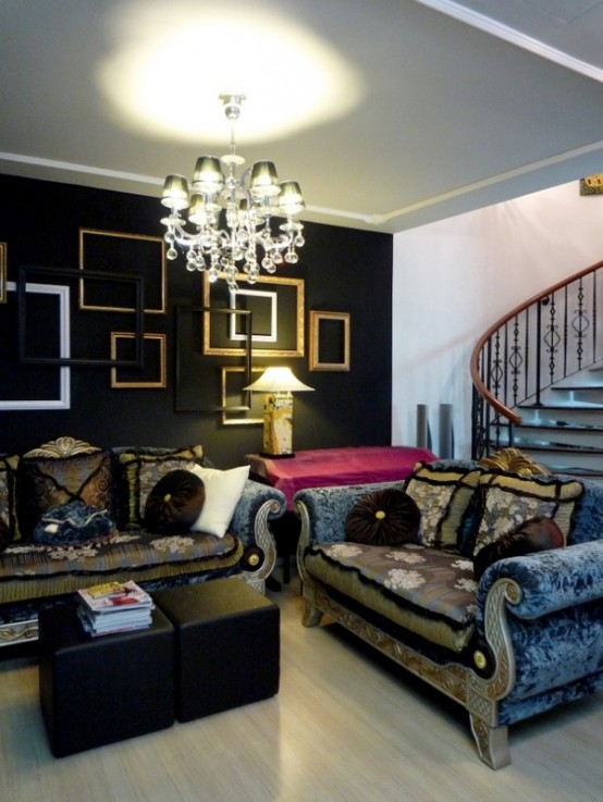 a refined soft Gothic living room with a black wall with empty frames, exquisite vintage furniture, a crystal chandelier and black ottomans