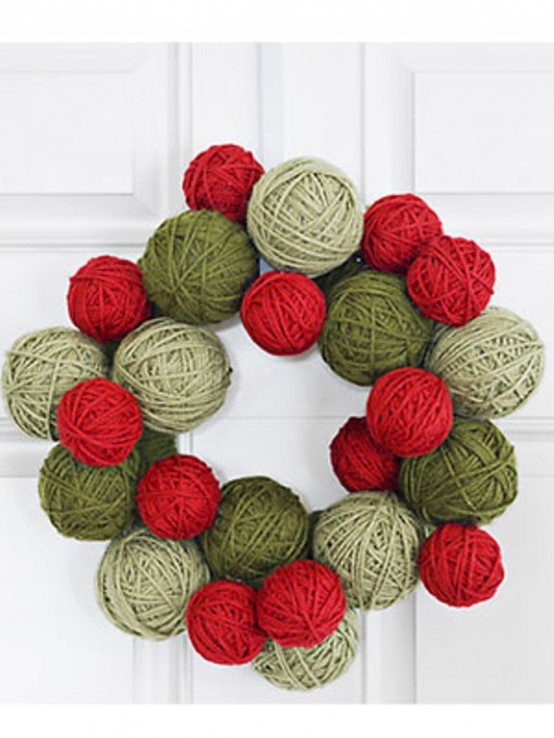 light and dark green plus red yarn balls form a cool and out of the box Christmas wreath in the traditional holiday colors