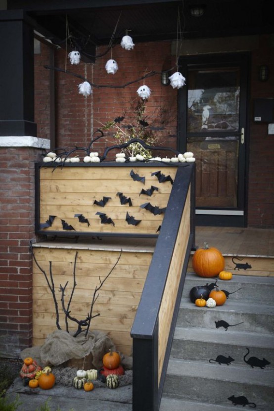 black bats, pumpkins, mice, mini ghosts, black branches are all you need for styling your porch for Halloween