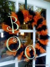 a bold black and orange tulle wreath with some plastic letters is a cool colorful idea for Halloween