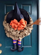 a creative Halloween wreath of burlap, a witch hat with an orange bow, witch legs and a glitter broom is a fun idea, especially for a kids’ party