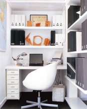 a small working nook with lots of open shelves, a small built-in desk, a white chair and a basket is a cool nook for working