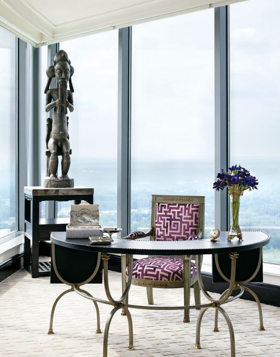 an eye-catchy home office with glazed walls, a vintage desk and a vintage chair, a black table and art, fantastic views of the city