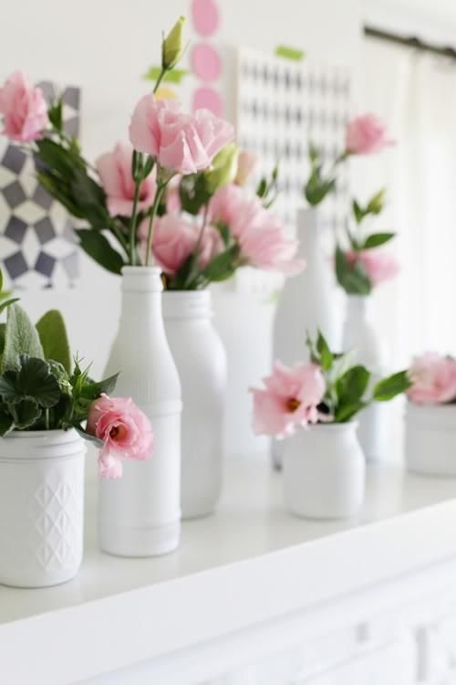 vintage bottles and jars painted white, with pink blooms in them will be a nice mantel arrangement to try