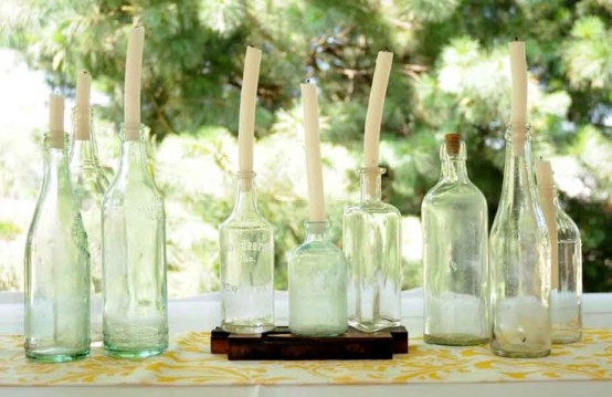 an arrangement of vintage bottles with candles is a cool idea for decorating your indoor and outdoor spaces