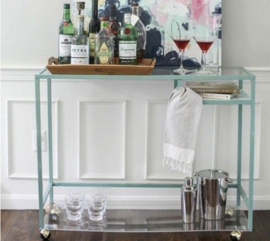 a lovely and easy home bar cart with a Vittsjo table hacked with casters and clear glass, with lots of wine and glasses