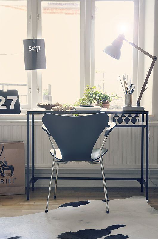 a Scandi working space by the window, with a black desk that is a Vitssjo table, a modern black chair and a table lamp, some greenery to refresh the space