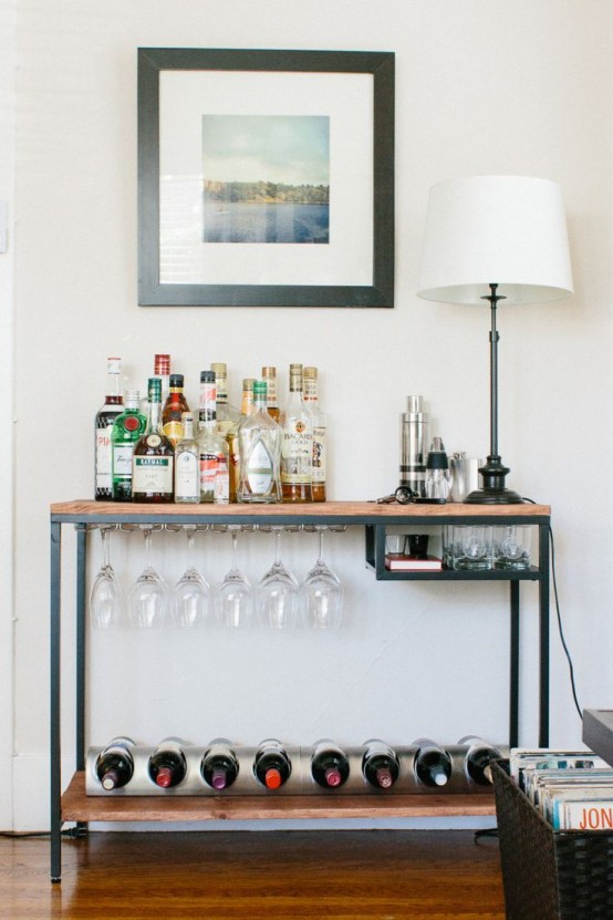 an IKEA Vittsjo table renovated with a wooden countertop and a shelf and used as a home bar with glasses and bottle holders is a cool idea