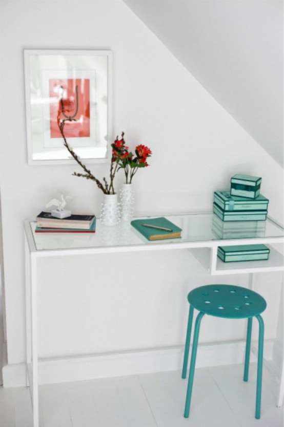 a small attic working space with an IKEA Vittsjo desk, a turquoise stool and a bold artwork is a lovely idea for tiny spaces