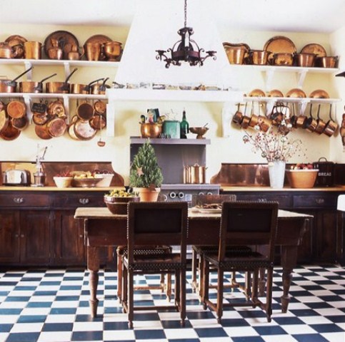 long open shelves along the whole wall for storing tableware, pots, pans and hanging some on the hooks