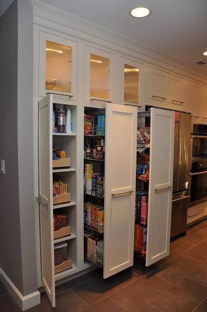 a built-in pantry with large vertical drawers will accommodate a lot of your stuff and will be a nice solution for storage