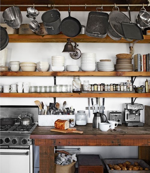 super long open shelves for storing al the tableware and a rail for hanging pots, pans and other things