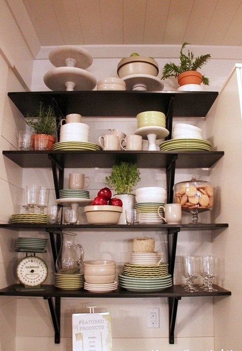 dark wall-mounted open shelves taking an awkward nook to make the maximal use of it