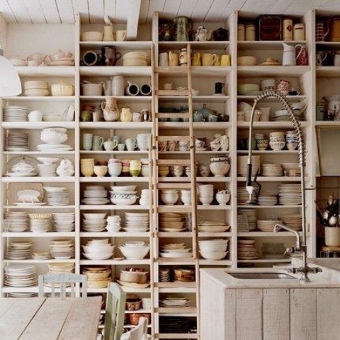 a whole wall covered with a large open storage unit for tableware is a great idea for any kitchen