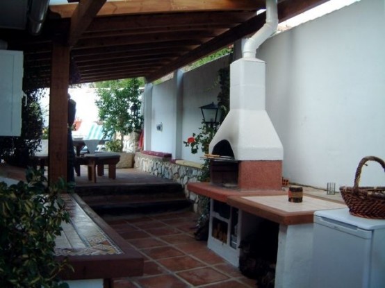an outdoor cooking zone with a cooking top and a hearth for cooking