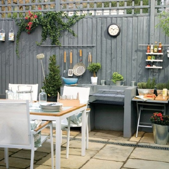 a comfortable dining area with a white dining set, light colored wood and a black countertop for cooking