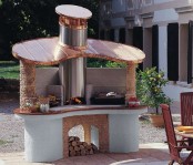 an outdoor grill and pizza oven plus some cooking space in one unit for a cool outdoor bbq space