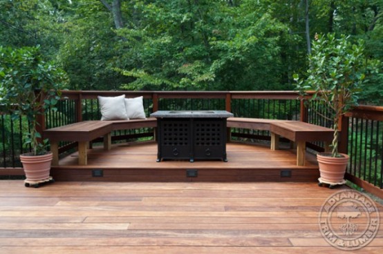 a small rustic deck with a built-in bench, a table with storage and some potted plants for a touch of freshness