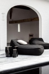 black upholstered lounger chairs styled as bean bags are perfect for a contemporary or minimalist outdoor space