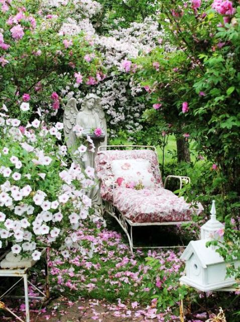 an elegant white metal lounger with bright floral upholstery and pillows is ideal for spring and summer outdoor spaces in vintage style