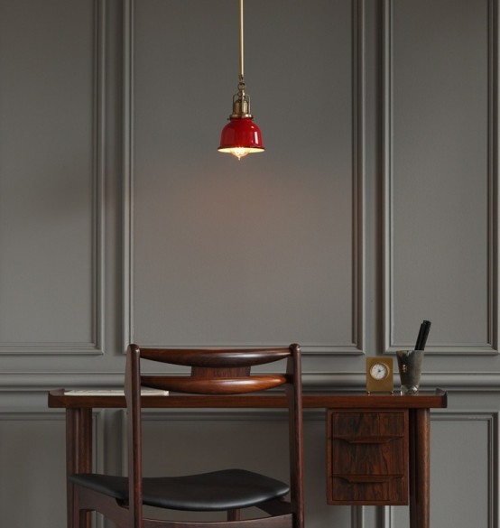 a chic working nook wiht grey paneling, a stained desk and a chair, a red pendant lamp is a bold and very minimal space
