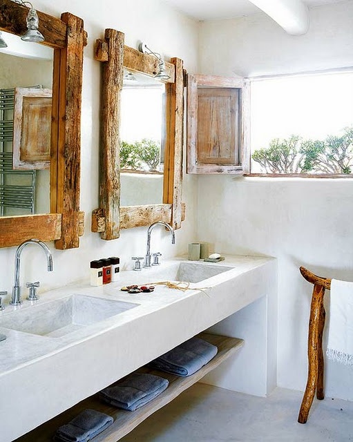 a tropical bathroom with rustic touches, driftwood frame mirrors and legs