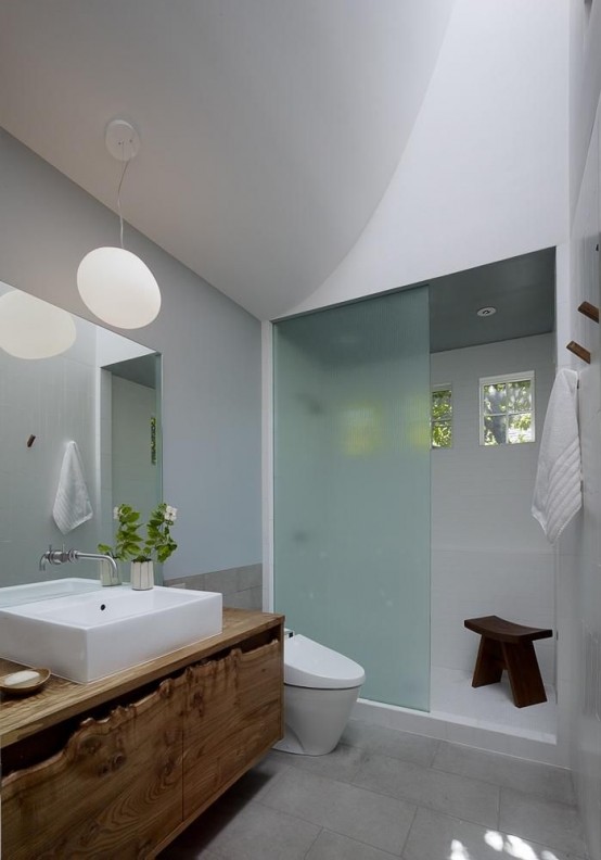 a contemporary bathroom with a living edge vanity for a rustic touch