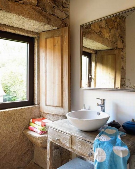 stone walls, wooden shutters and a wooden vanity for a rustic meets vintage look