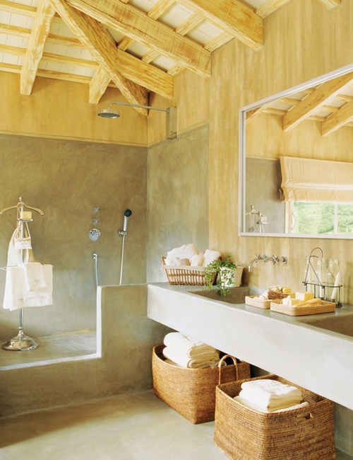 a contemporary farmhouse bathroom done in concrete and light-colored wood