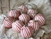 rustic Christmas ornaments wrapped with red and white stripes, with twine and pearls
