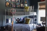 a modern shared teen boy bedroom with a metal bunk bed, a striped ceiling, a leather chair and a gallery wall