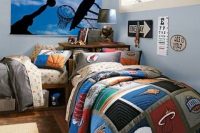 a bright sporty shared teen bedroom with blue walls, a poster, simple beds with bright sporty bedding