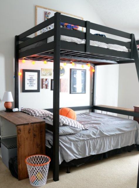 a small shared teen boy bedroom with a black bunk bed, a gallery wall and a small console table plus a lamp